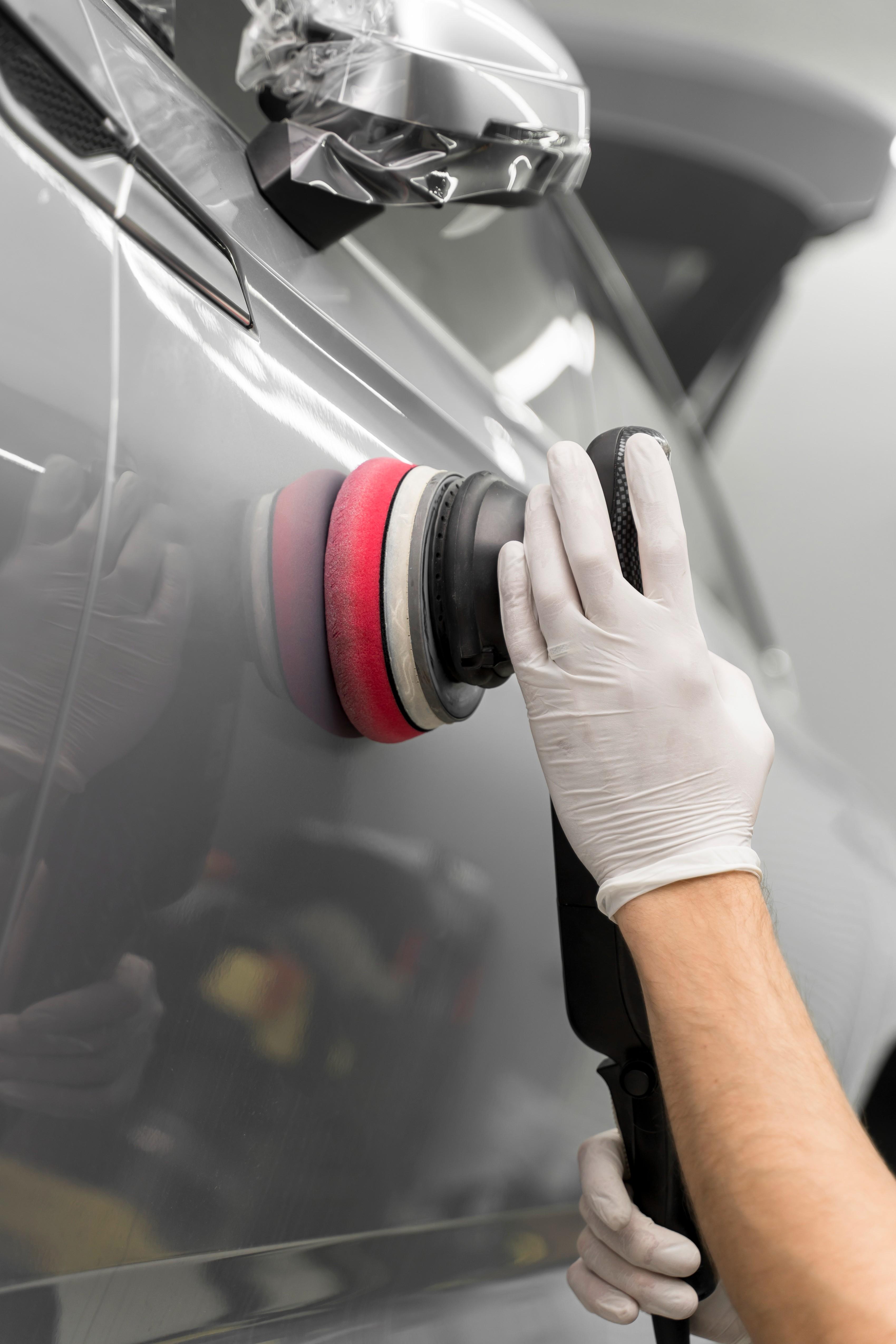 A luxury car being detailed in a professional setting